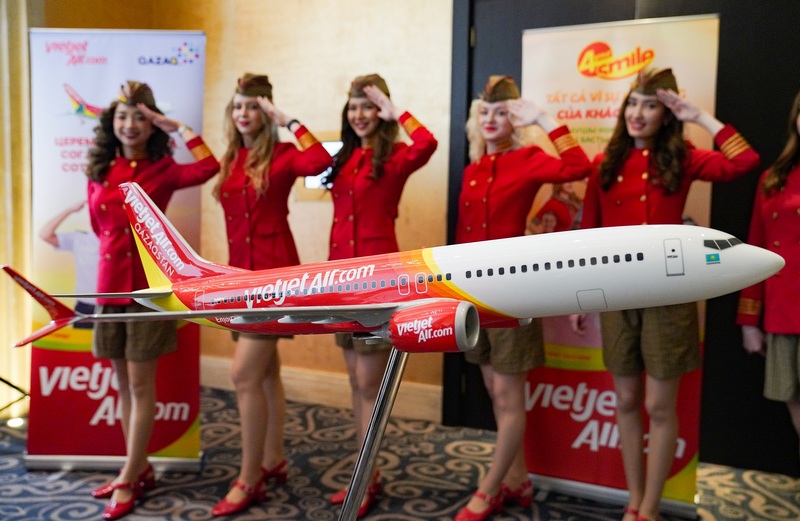 Boeing 737MAX aircraft model in Vietjet Qazaqstan livery with the Kazakh crew at the background